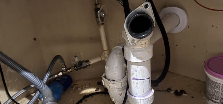 Under sink plumbing repair area Under sink plumbing repair area